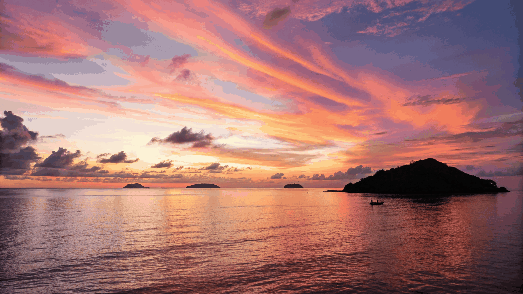 Expansive calm sea horizon reflecting indigo and rose twilight